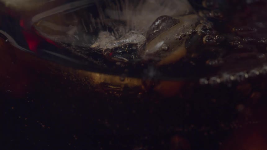 Whiskey being served on a glass filled with ice cubes