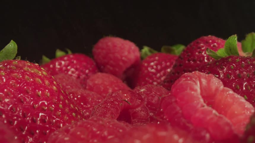 Water falling on strawberries and raspberries set up for a photo shoot