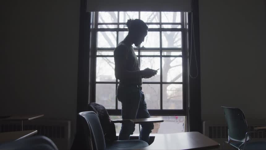 A student stands in the empty class