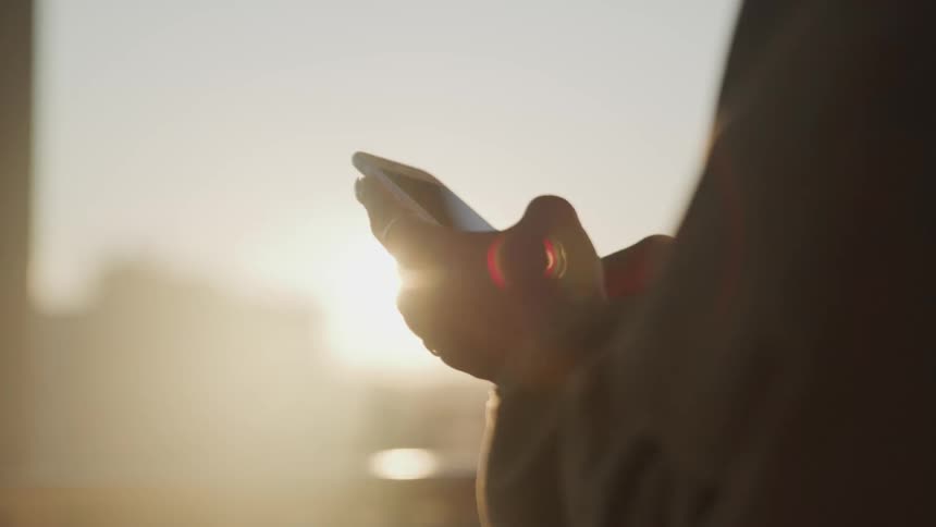 A female scrolling through her cell phone