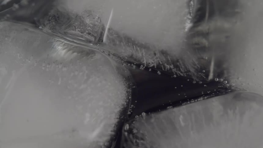 Bubbles floating around cubes of ice in water