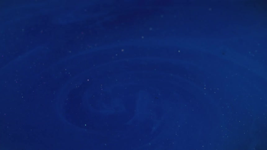 Swirling blue liquid with glitter