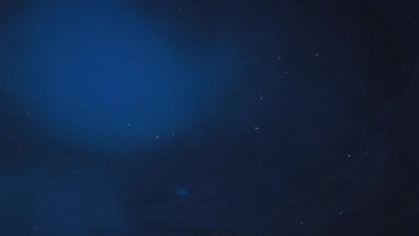 Particles floating in blue and black liquid