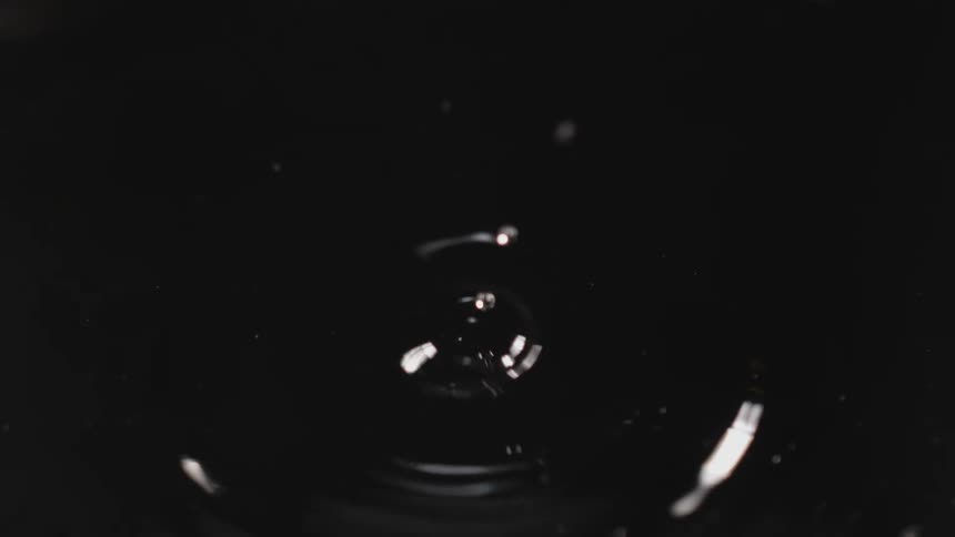 A droplet of water falling in to water