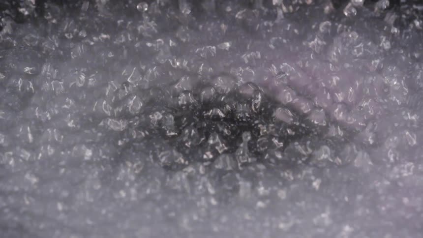 Close up of bubbles rising in boiling water on a pan