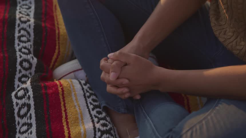 A person is sitting on a blanket