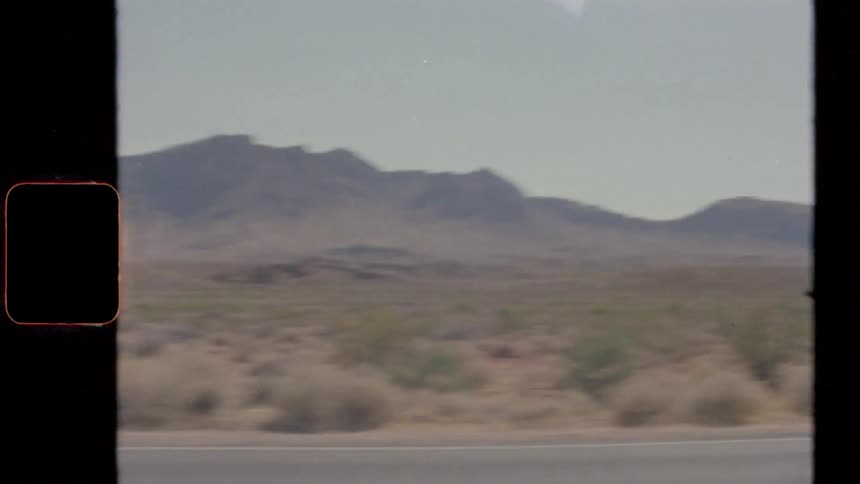 Vintage footage of a grassland with hills in the distance