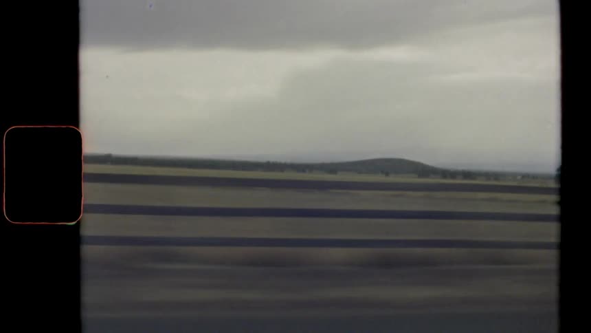 Vintage footage of a farmland with farm equipment on it