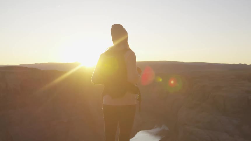 A woman is hiking outdoors at dusk