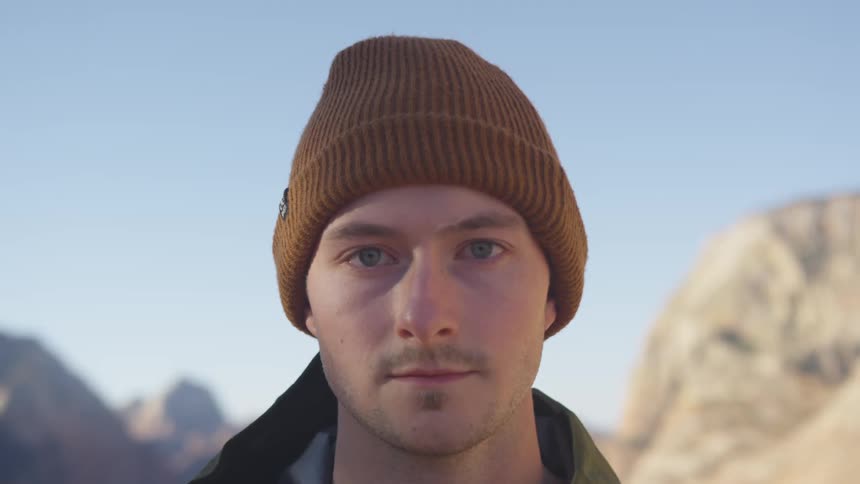 A man is looking forward by a mountain