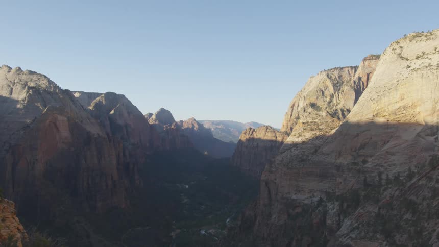 River flows on the green valley of a canyon in the morning light