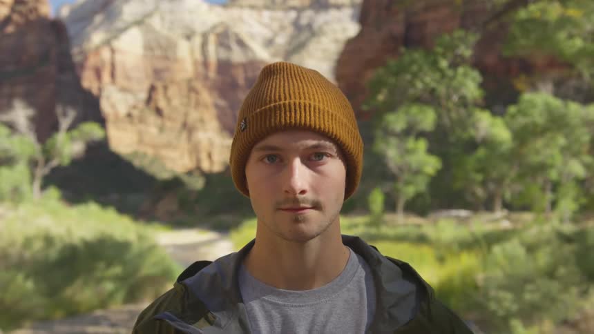 A teenage boy standing in front of a canyon