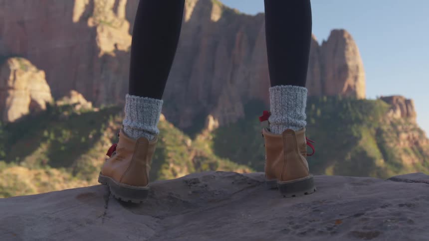A woman is hiking through a mountain landscape
