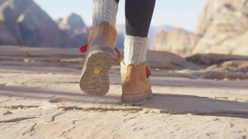 A person hikes to the cliff edge