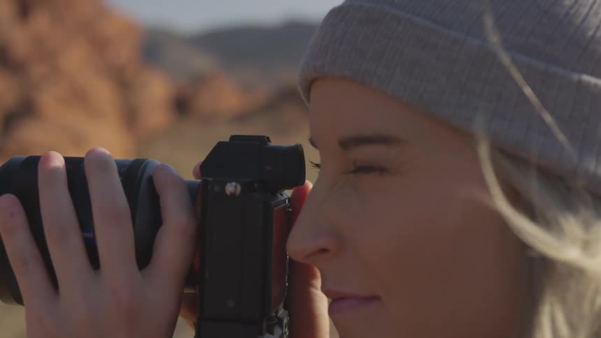 A teenage girl taking pictures outside