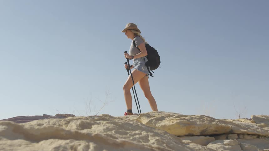 A woman is hiking across the mountains