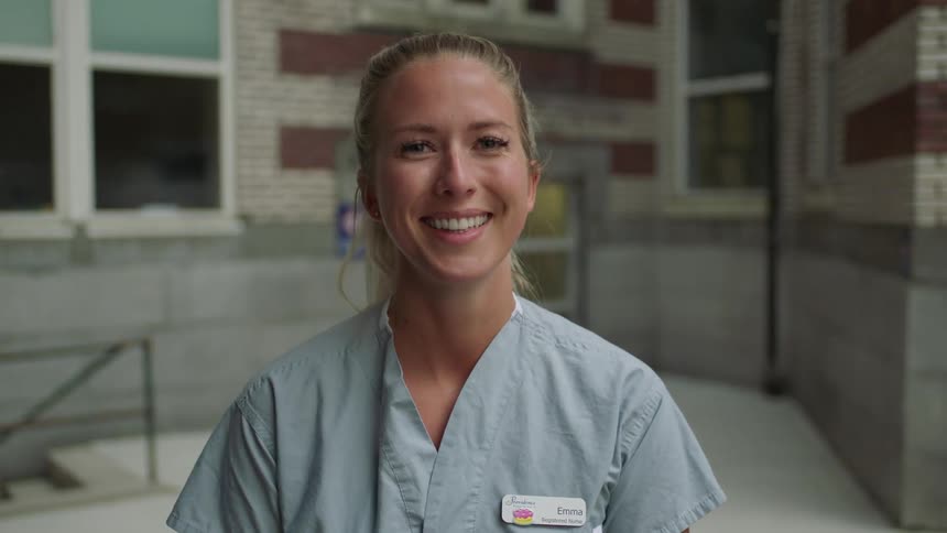 Blonde nurse takes off her face mask and smiles broadly