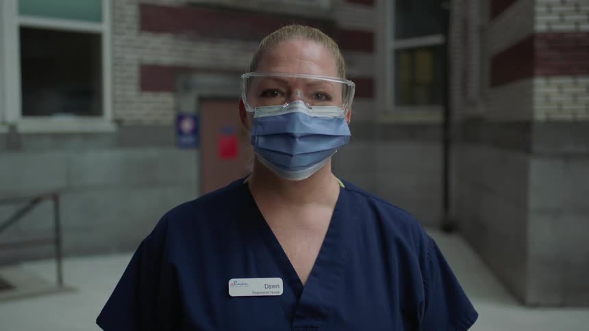 A woman is wearing a mask and goggles while standing outside