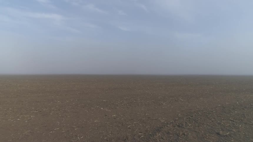 A vast desert with a bright blue sky in the background