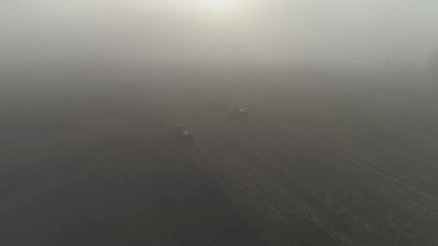 An aerial view of heavy fog over a field