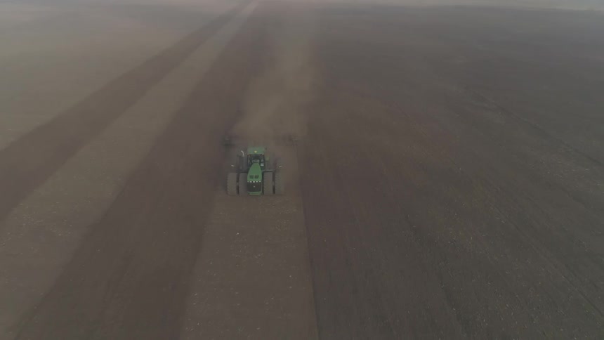 A plow plowing a field on a farm