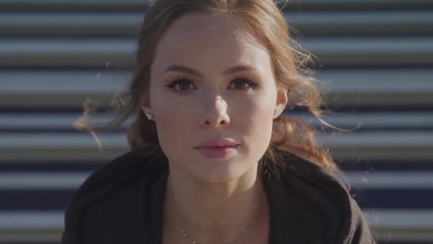 A teenage girl outside looks up