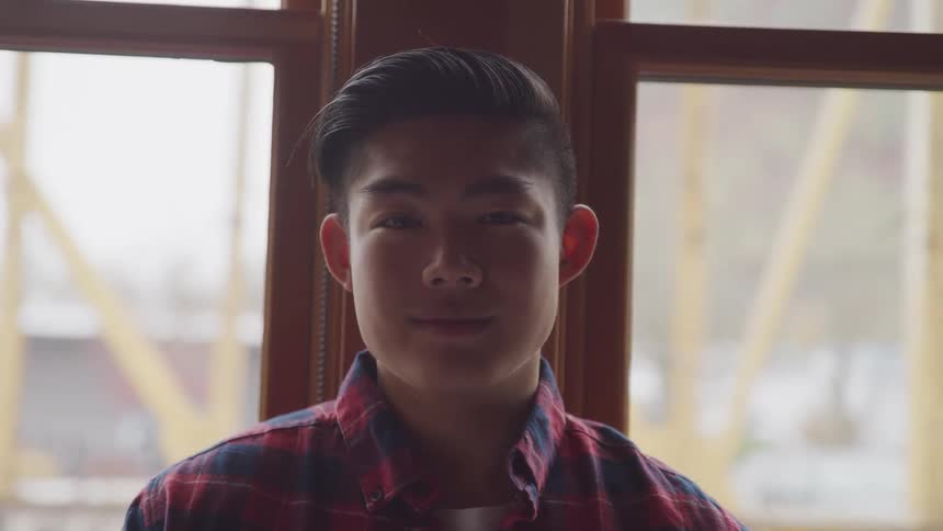 A teenager is riding the train
