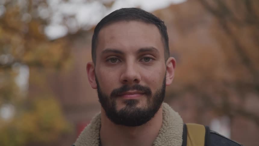 A man is standing in a city during autumn