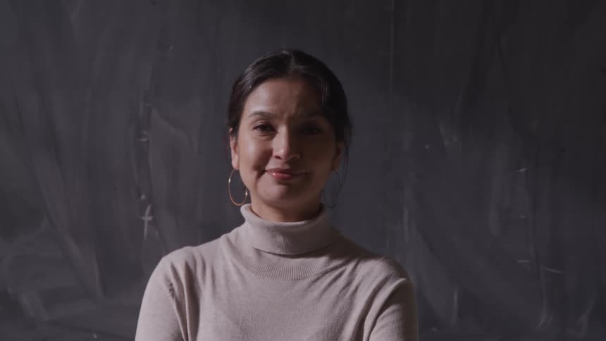 A teacher standing in front of a blackboard