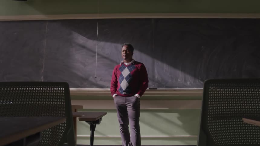 A teacher standing at the front of a classroom