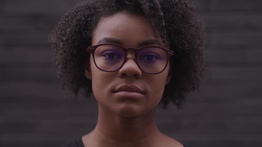 A woman is wearing glasses indoors