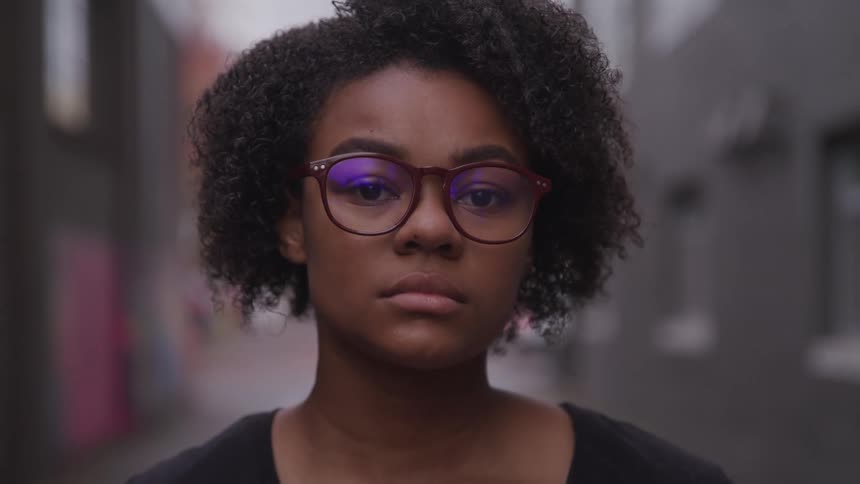 A young african american woman is wearing glasses
