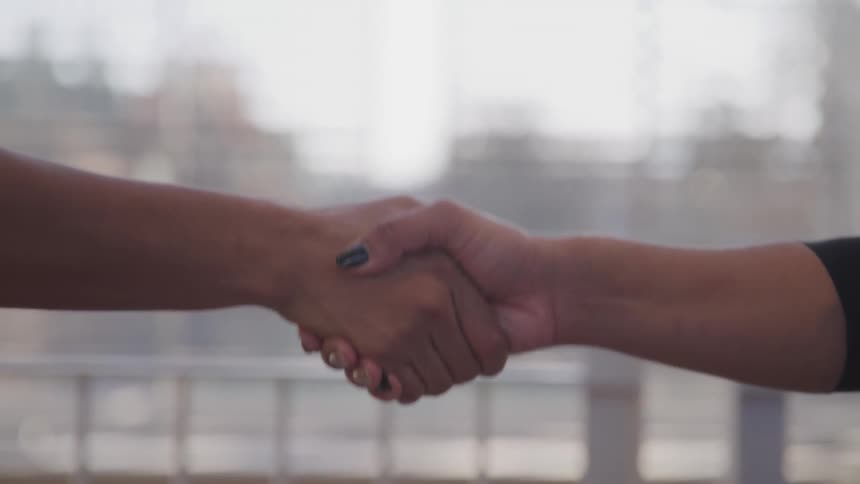 Two women shaking hands