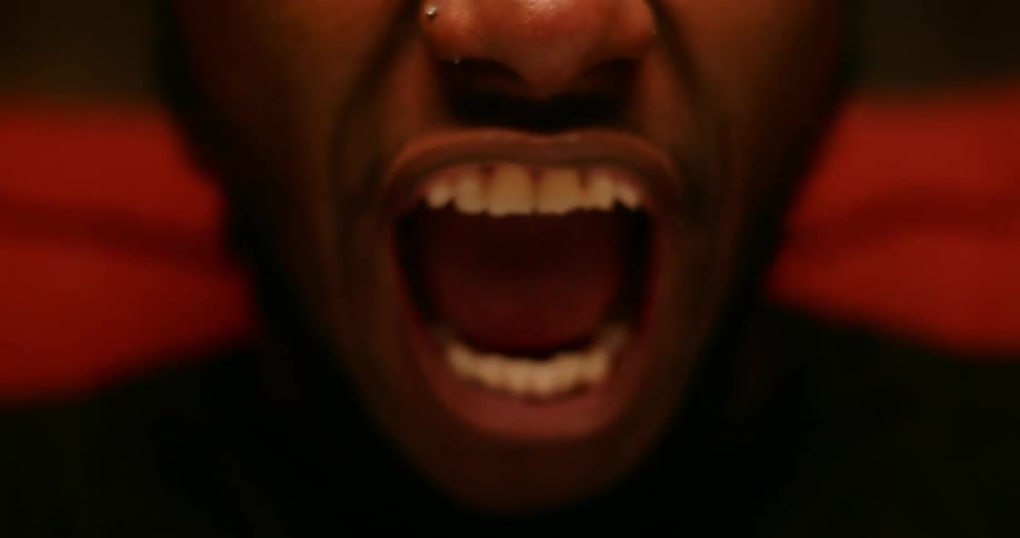 Close up of the mouth of a man screaming