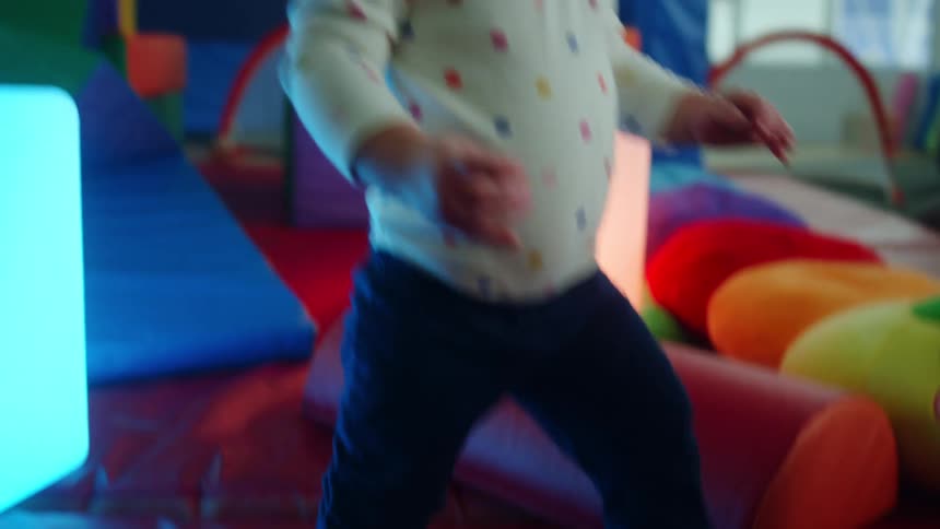 A baby playing with toys and smiling