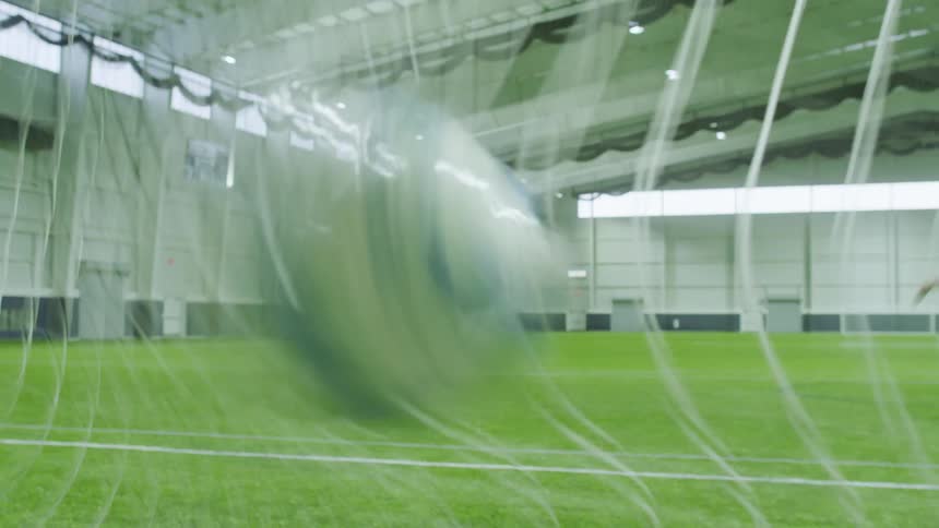 A soccer ball flies into the back of a soccer net causing the camera to shake