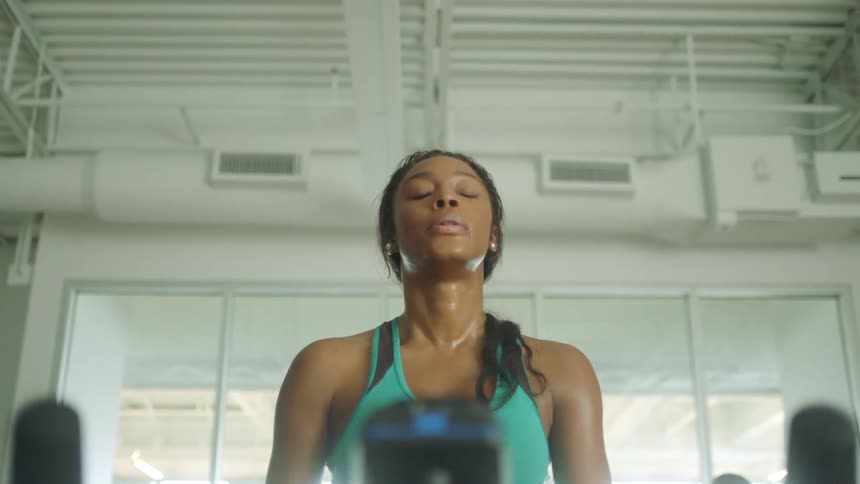 Young woman rides a stationary bicycle in a gym