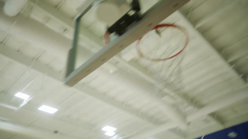 A man jumps and shoots a basketball during a game