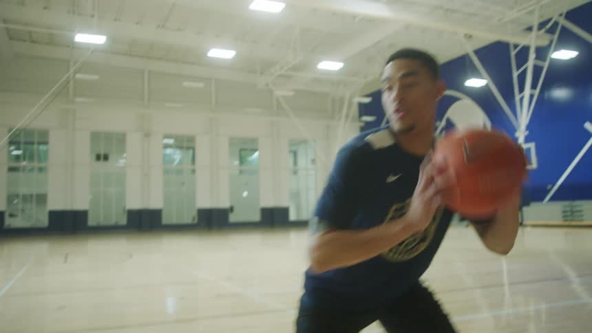 Man playing basketball on indoor court