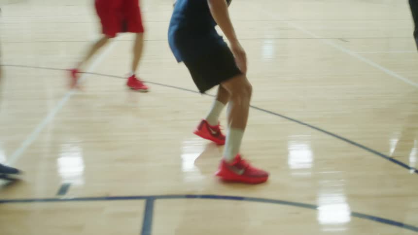 People playing basketball on an indoors court