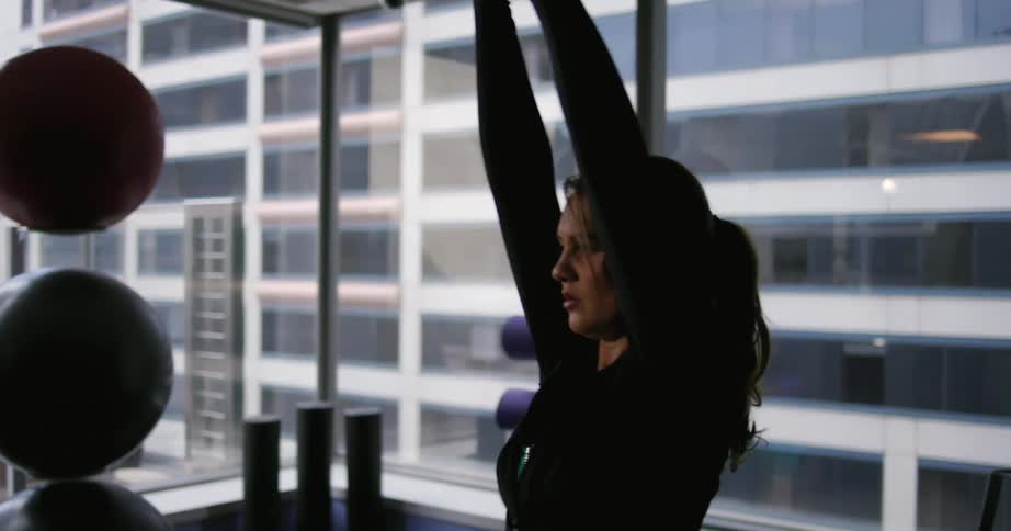 A woman lifting weights indoors