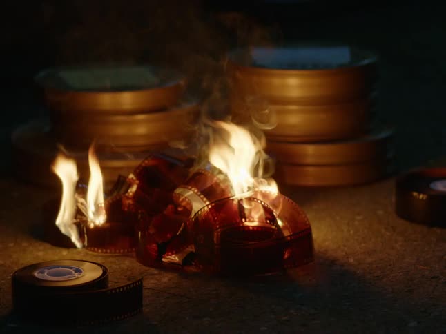 Unreeled film burning on ground