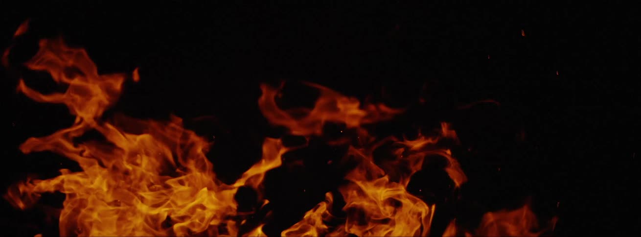 Flames from fire against black background