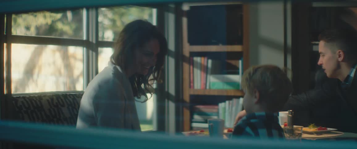 Happy family playfully talking while eating at home