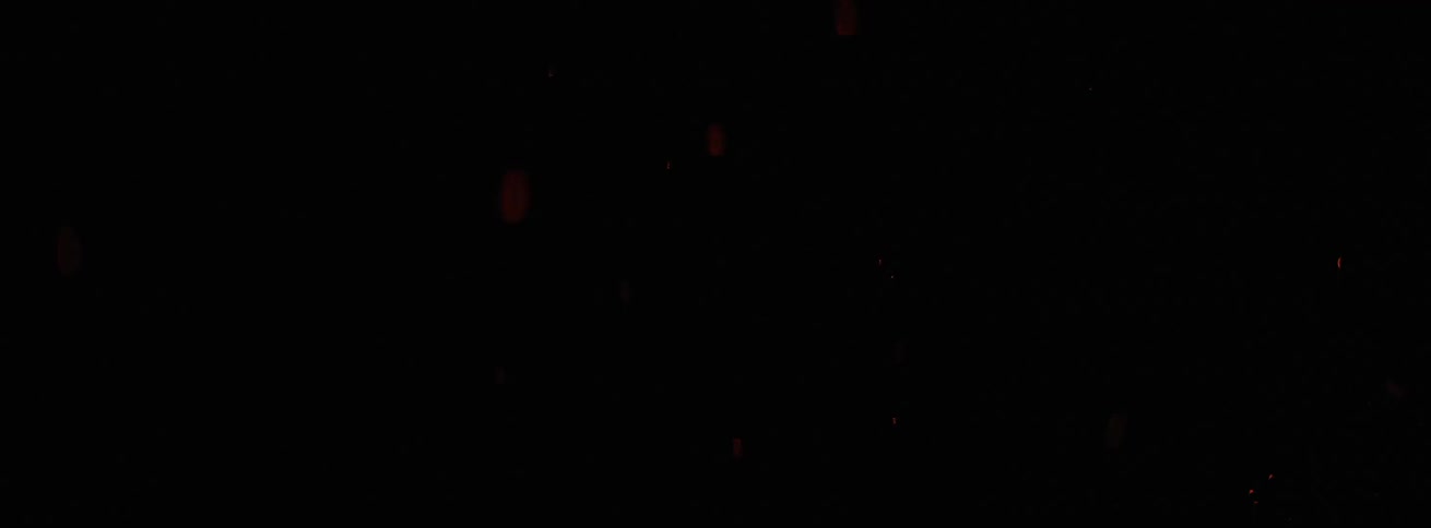 A fire burning outside at night
