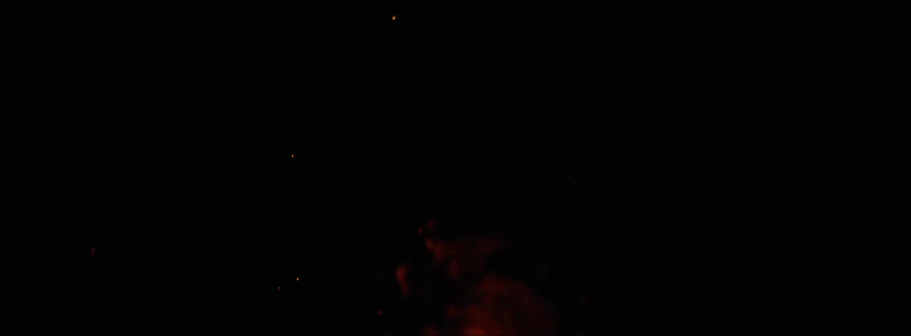 Tip of orange flames dancing against a black background