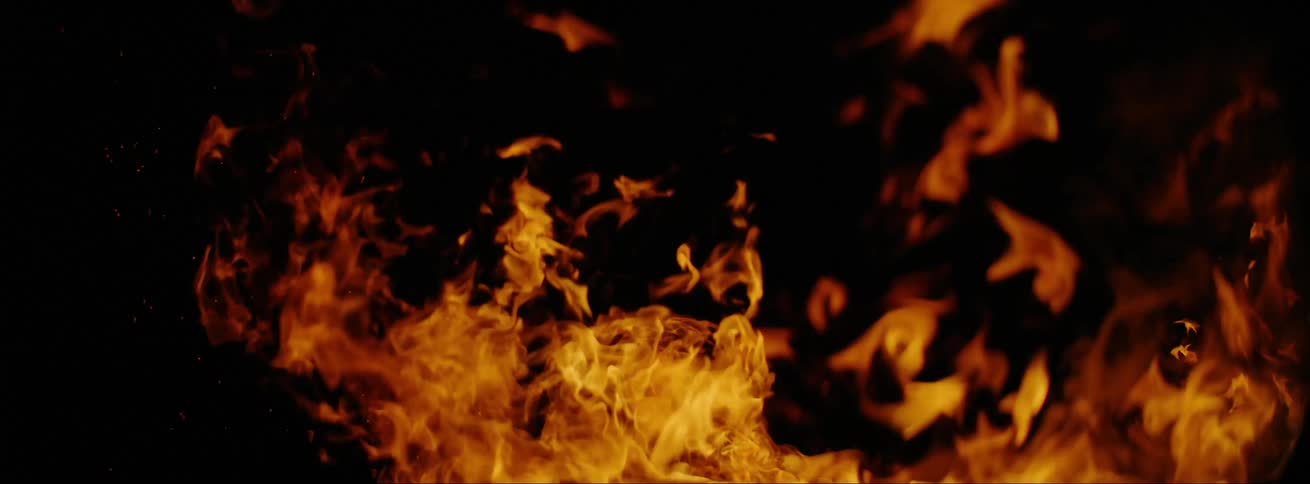 Red flames burn in completely dark surroundings