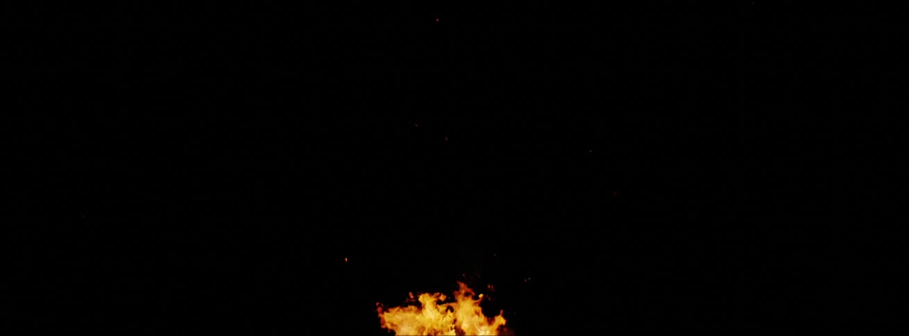 A fire is burning outdoors at night