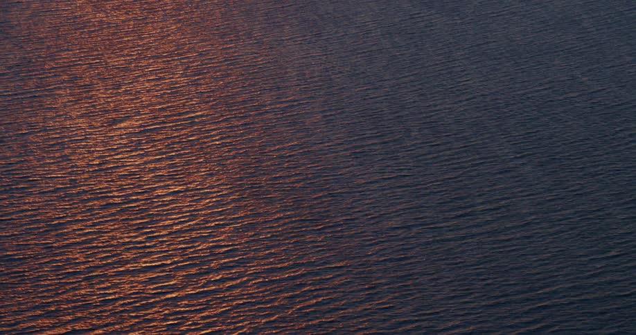 Sunlight reflecting on rippling water at sunset