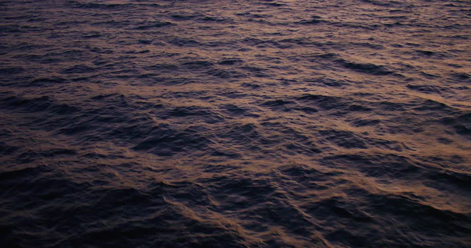 Aerial view of a sea surface at dusk